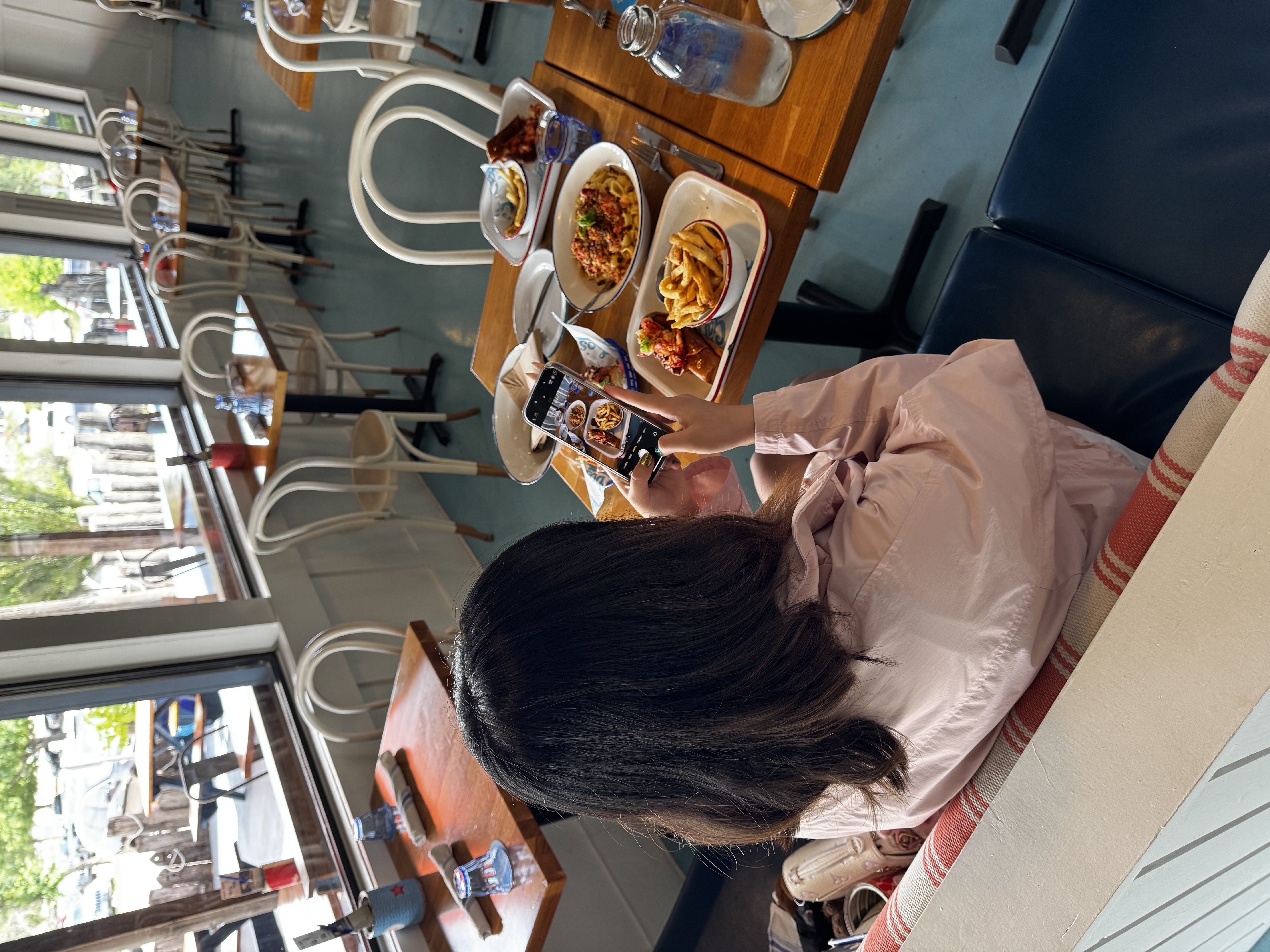 Amanda photographing dishes at a restaurant for an anonymous review
